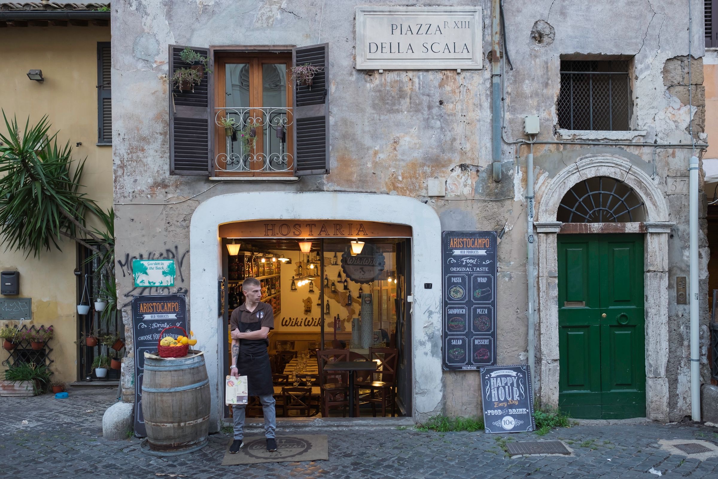 Doorway of a Rome building with blurred brass plates beside the entrance