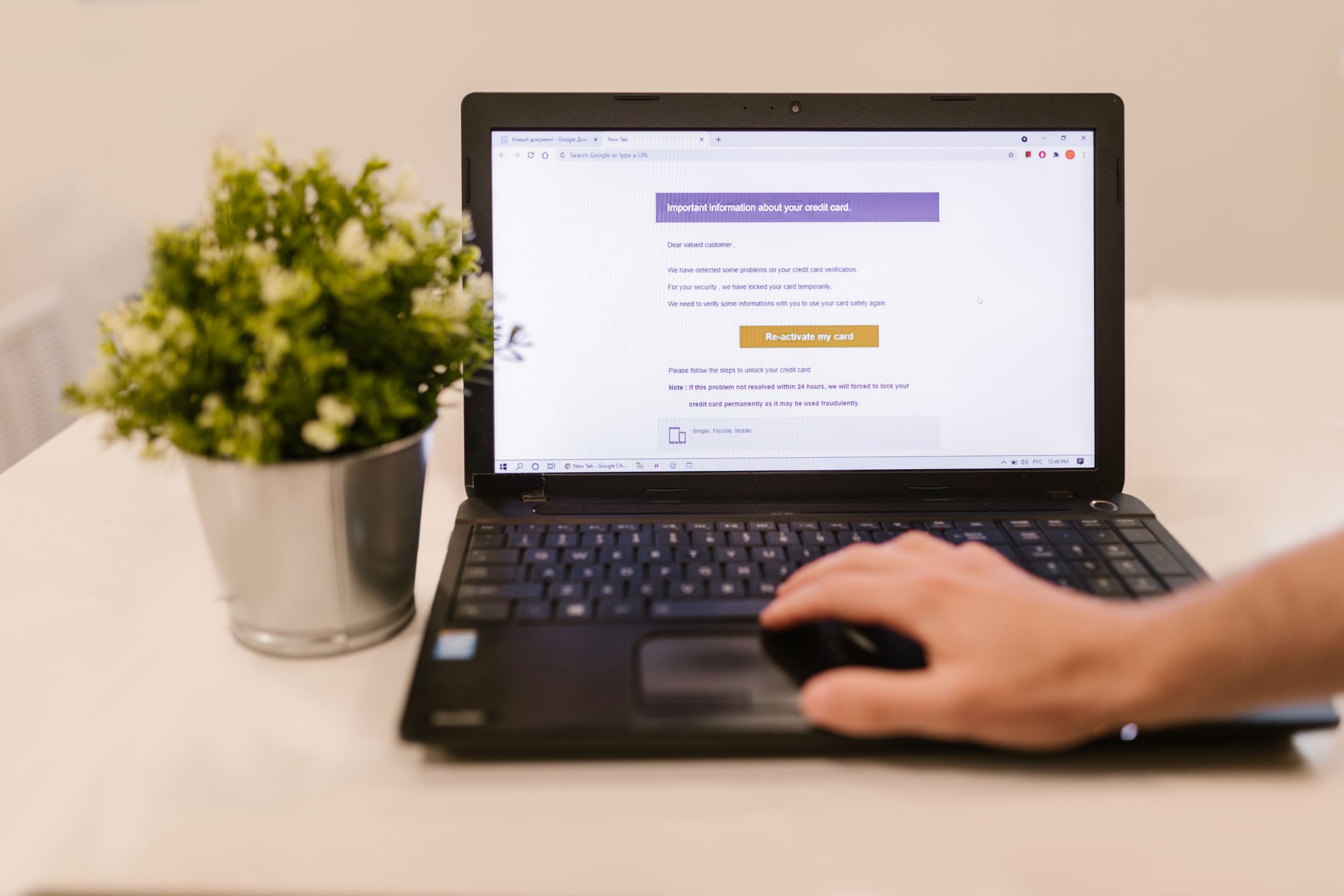 A laptop, a smart-card reader and a folder of company papers on an office desk