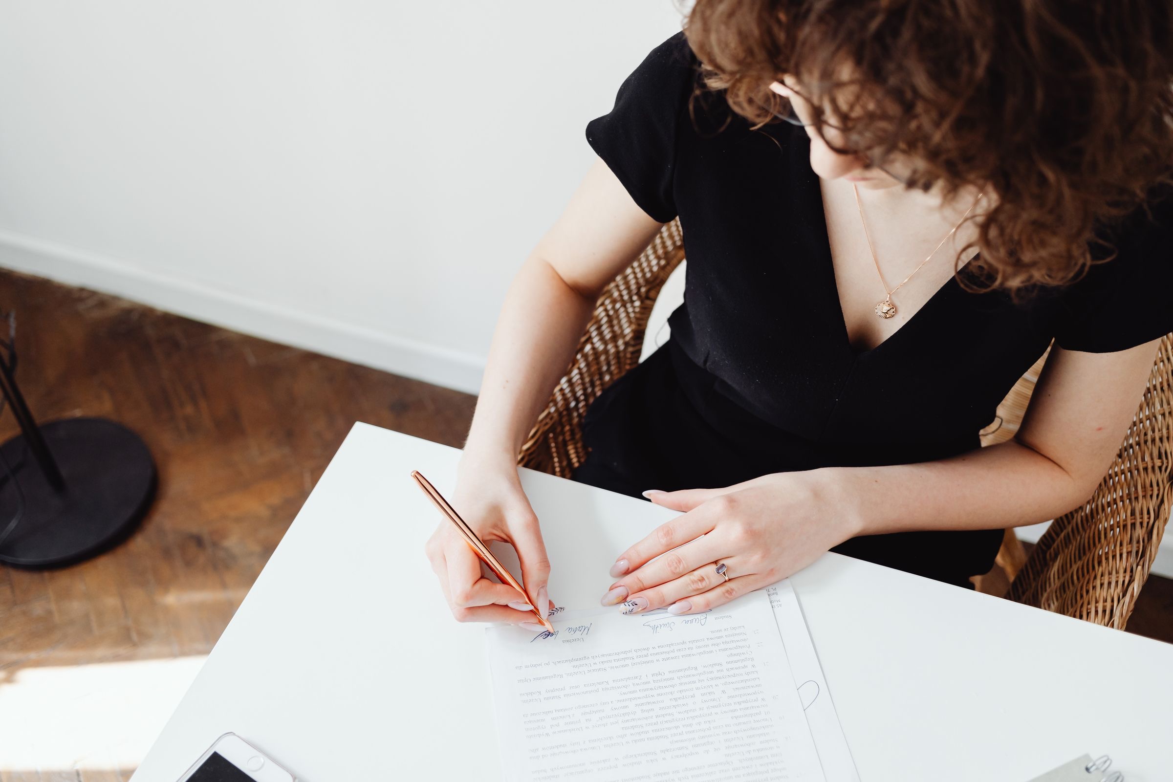 Signed deed, pen and digital-signature token on a notary's desk