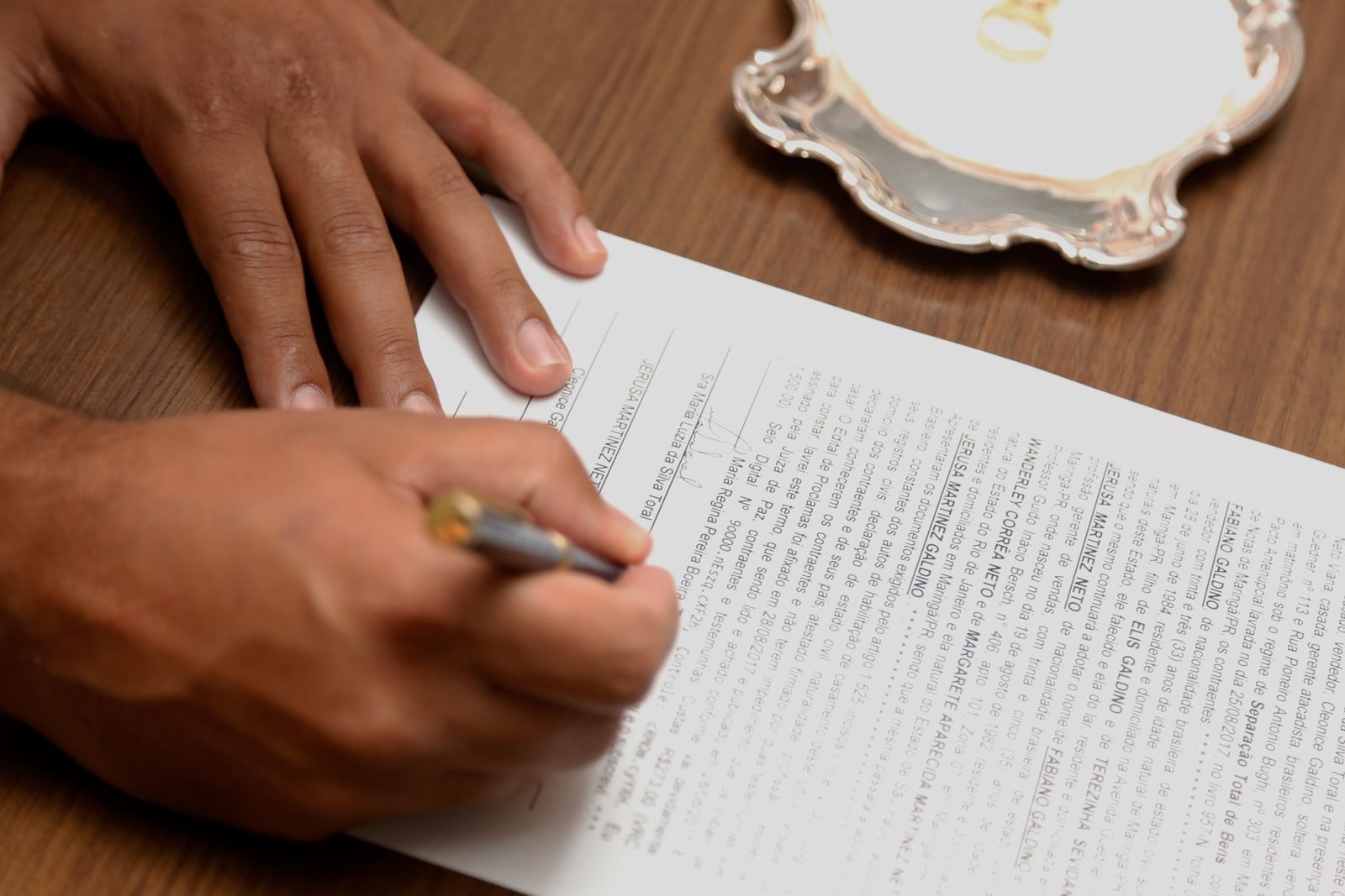 Stamped documents and a passport laid out on a desk