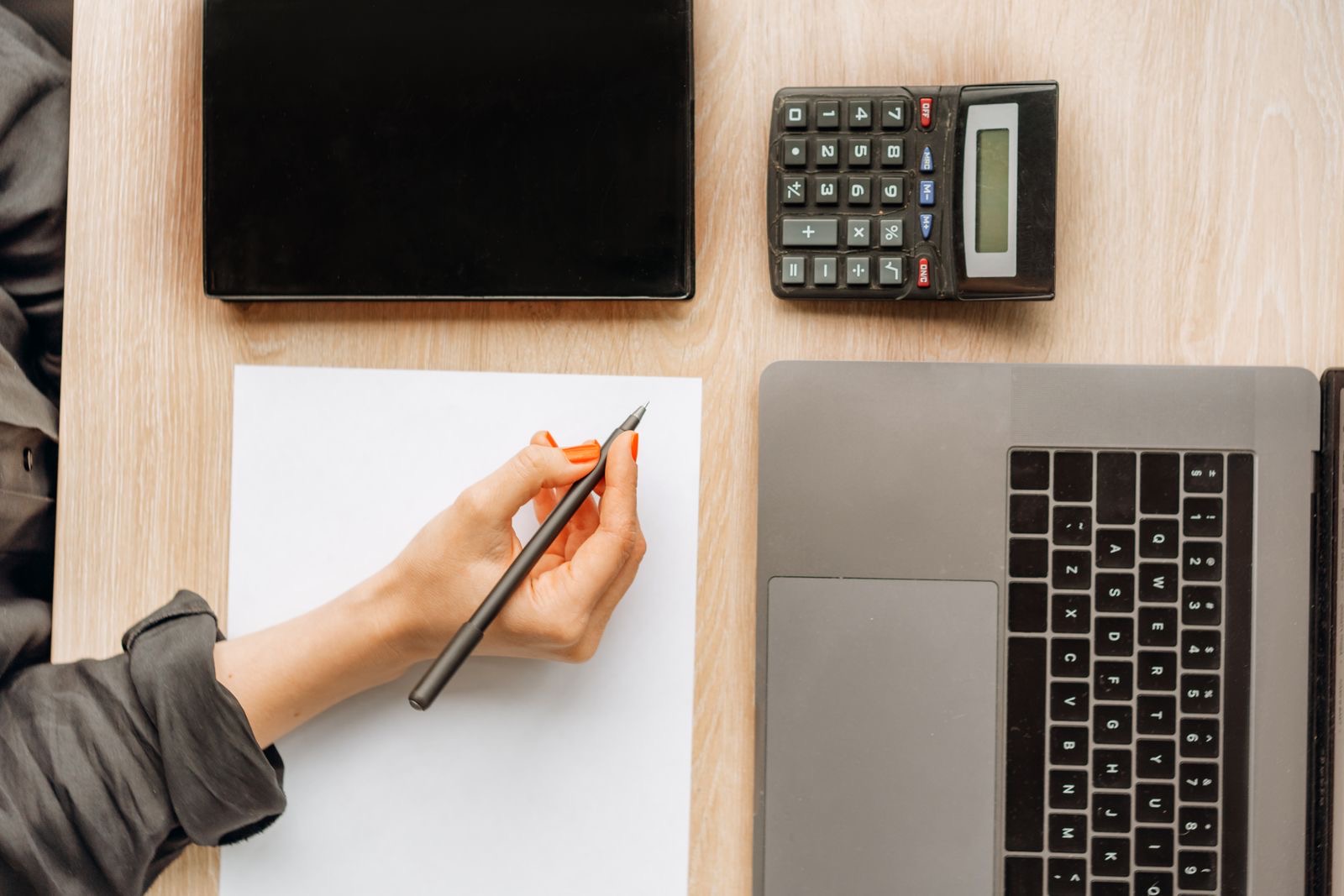 A desk with a laptop and tax papers