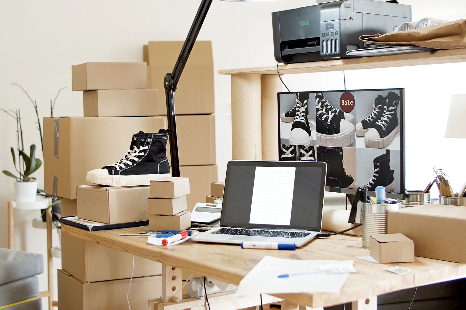 Shipping boxes on a desk beside a laptop