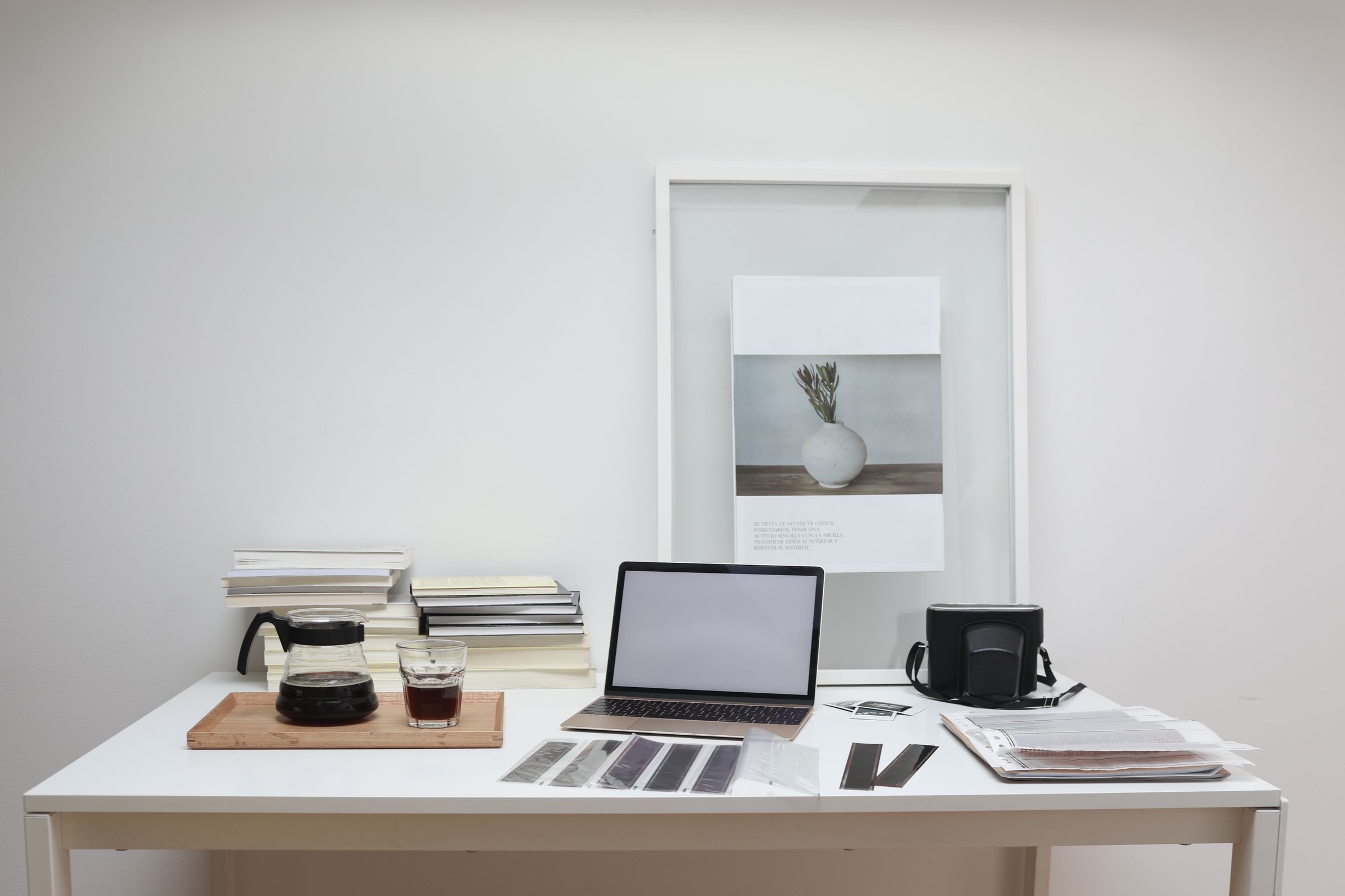 A laptop and a printed invoice on an office desk