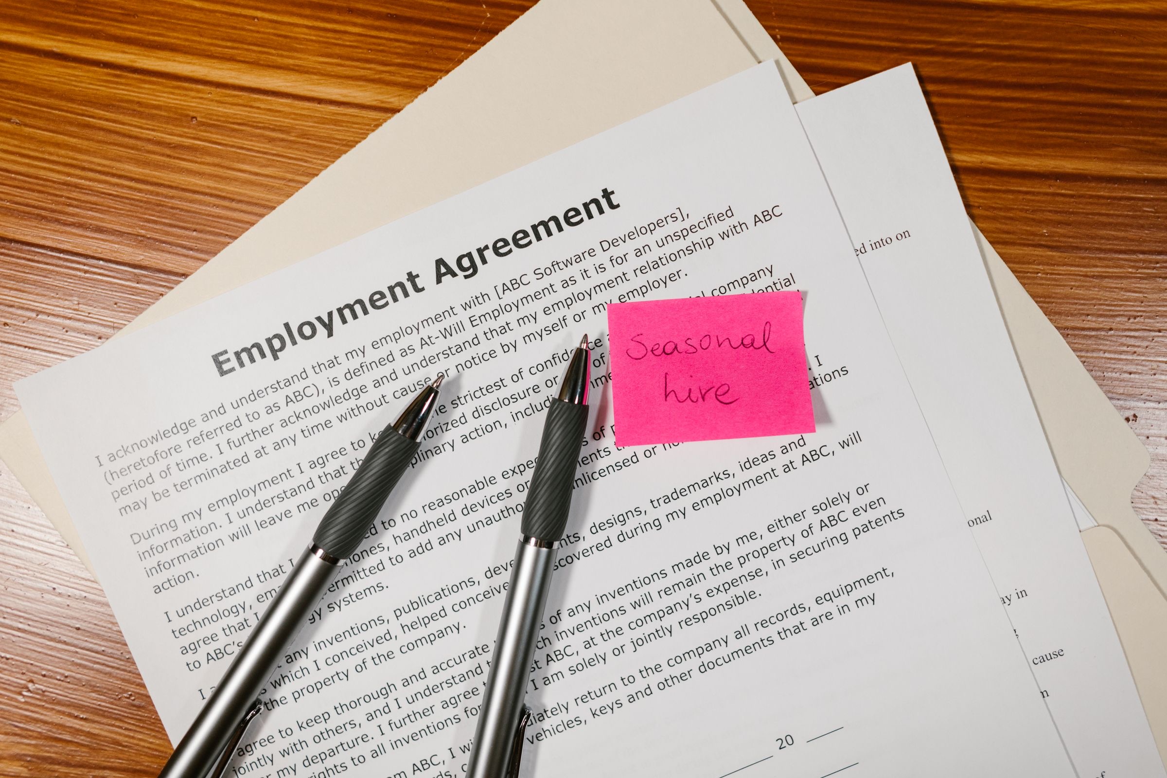 An employment contract and a pen on a small office desk
