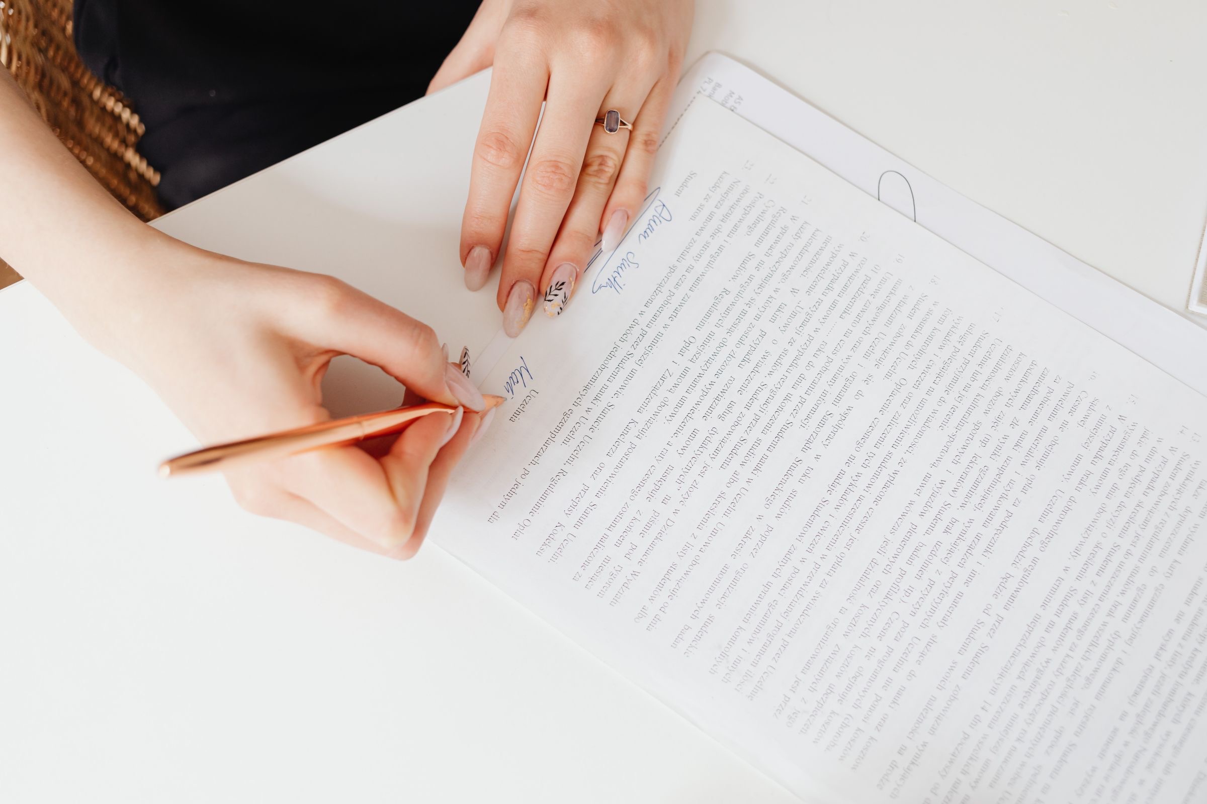 A signed deed transferring the quotas of an Italian company, lying on a desk beside a pen