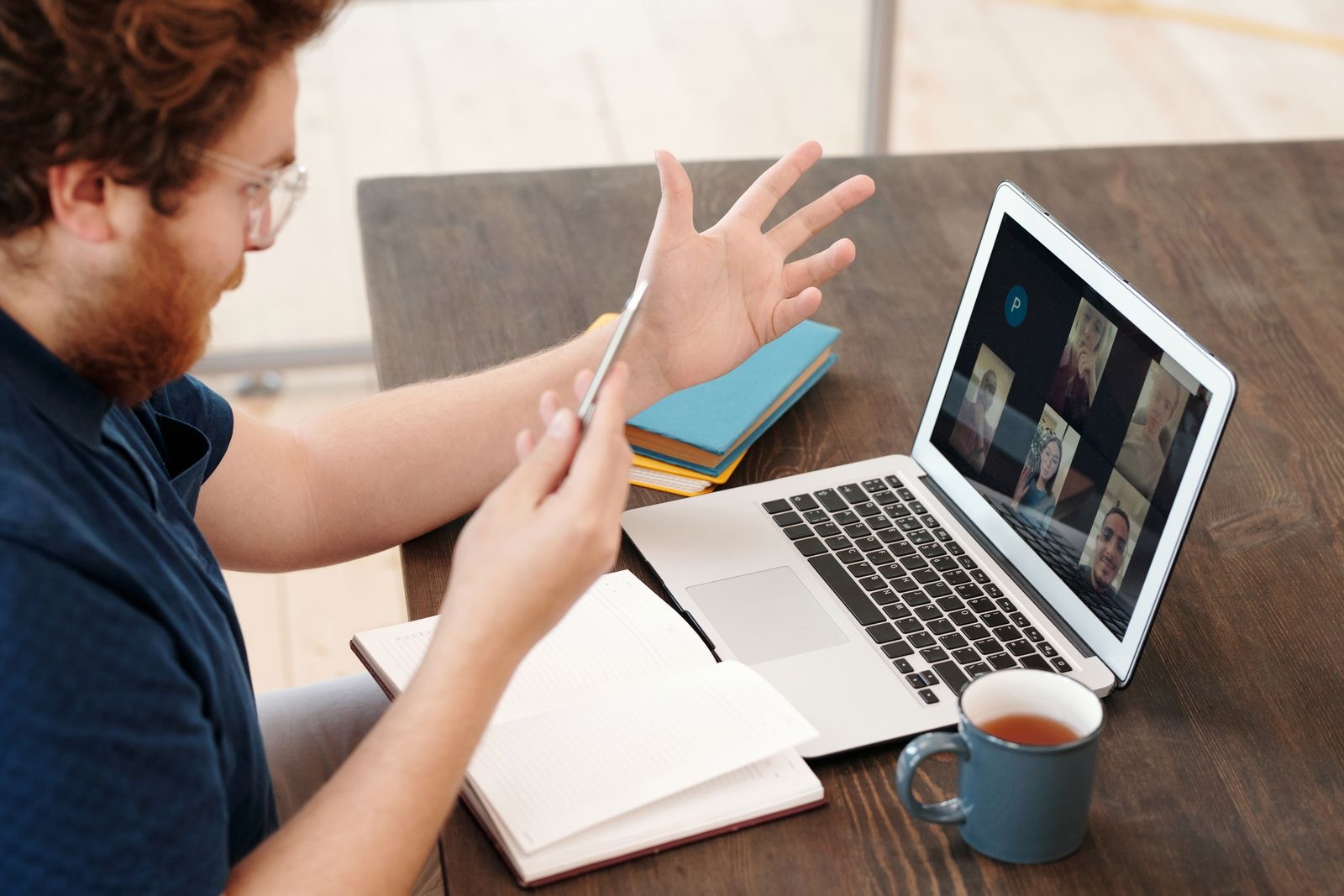 A person on a video call at a home-office desk